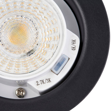 Close-up of a light bulb with labeled color temperatures on a white background