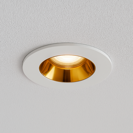 Gold downlight recessed ceiling light fixture on a white ceiling