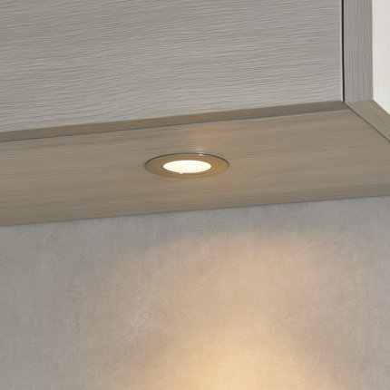 Close-up of a recessed light fixture in a ceiling corner.
