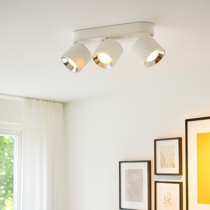Ceiling light fixture in a room with framed pictures on the wall