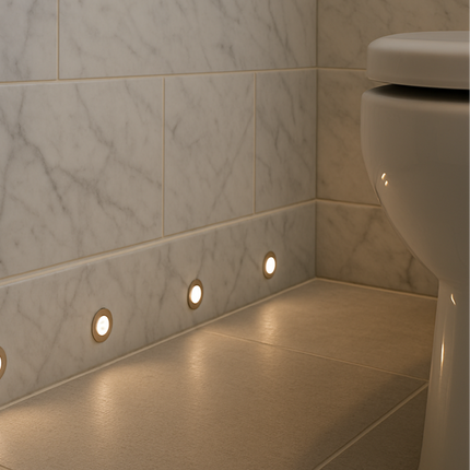 Bathroom corner with tiled walls and floor, featuring recessed lights.