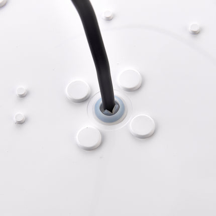 Close-up of a black cable being plugged into a white electrical outlet.