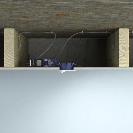 Under-surface view of a wooden floor with cables and a power strip.