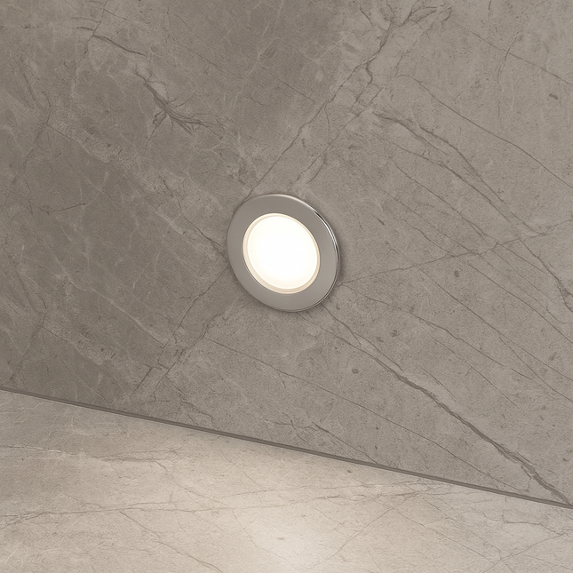 Round recessed plinth light on a textured gray wall