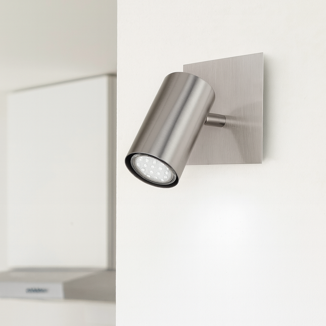 Modern wall-mounted light fixture on a white wall