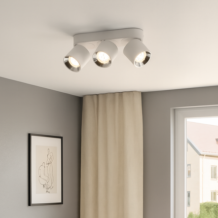 Ceiling light fixture in a room with a window and curtain