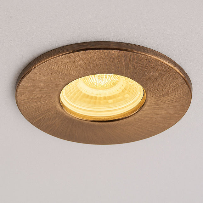 Round gold ceiling light fixture on a gray background