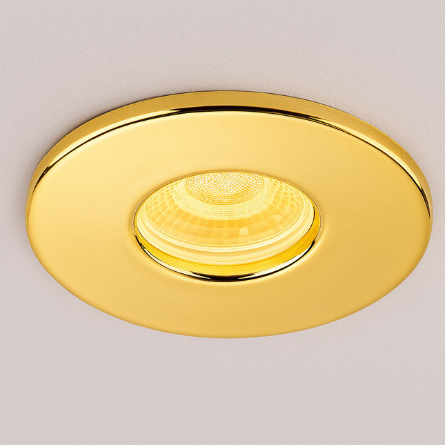 Gold recessed ceiling light on a neutral background