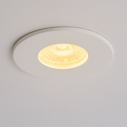 Round recessed ceiling light fixture on a plain background