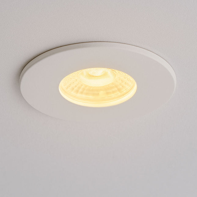 Round recessed ceiling light fixture on a plain background
